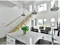 Bright open-concept kitchen and dining space featuring high ceilings, stainless steel railings, with a crisp, white color scheme at 1130 N 2Nd St # 401, Phoenix, AZ 85004
