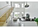 This bright living space features high ceilings, large windows, stainless steel railings, with a dining area and a crisp, white color scheme at 1130 N 2Nd St # 401, Phoenix, AZ 85004