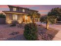 Beautiful two-story home with desert landscape and a charming desert stream feature in the front yard at 1179 E Regent Dr, Gilbert, AZ 85298
