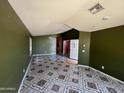 Open-concept living room features recessed lighting and decorative tile flooring at 15329 W Melissa Ln, Surprise, AZ 85374
