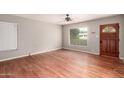 Inviting living room with hardwood floors, a large window, and a classic wooden front door at 1609 E Williams N St, Tempe, AZ 85281
