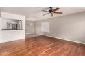 Spacious living room featuring hardwood floors, a ceiling fan, and ample natural light at 1609 E Williams N St, Tempe, AZ 85281