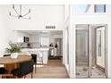 Modern kitchen with stainless steel appliances, white cabinetry, and an adjacent dining area at 1631 E Gardenia Ave, Phoenix, AZ 85020