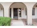Inviting front entrance with covered archway, decorative door, and low-maintenance desert landscaping at 16510 E Palisades Blvd # 42, Fountain Hills, AZ 85268