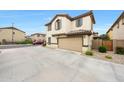 Lovely house features a spacious driveway leading to an attached garage, complemented by desert landscaping at 16540 W Culver St, Goodyear, AZ 85338