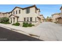 Charming two-story home with landscaped front yard and a private driveway leading to a garage at 16540 W Culver St, Goodyear, AZ 85338