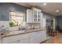 The well-appointed kitchen features white cabinetry, granite counters, ample counter space, and updated appliances at 1712 E Montebello Ave, Phoenix, AZ 85016