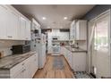 Bright, renovated kitchen with white cabinetry, modern appliances, and hardwood floors; a chef's dream at 1712 E Montebello Ave, Phoenix, AZ 85016