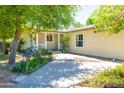 Beautiful front entrance featuring a porch and flower garden at 18051 E Happy Rd, Queen Creek, AZ 85142