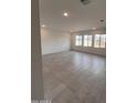 Expansive living room with tile flooring and lots of natural light from many windows at 18183 W Larkspur Dr, Goodyear, AZ 85338