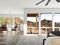 Sunlit bedroom with tile flooring, mountain views, and comfortable seating area at 1836 E Turquoise Ave, Phoenix, AZ 85020
