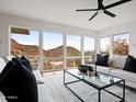 Bright living room featuring white sofas, modern furniture, and floor-to-ceiling windows with mountain views at 1836 E Turquoise Ave, Phoenix, AZ 85020