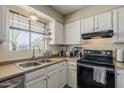 Close up view of a kitchen featuring white cabinets, neutral countertops, and stainless steel sink at 1838 E 2Nd Pl, Mesa, AZ 85203