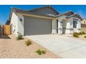 Lovely single-story home featuring a two-car garage and desert landscaping for low maintenance at 18418 W Monte Lindo Ln, Surprise, AZ 85387
