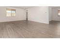 Spacious living room featuring neutral paint, tile floors and a bright, airy feel with lots of natural light at 18418 W Monte Lindo Ln, Surprise, AZ 85387
