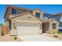 Attractive two-story home with a two-car garage and an easy-care desert-style landscaped front yard at 18456 W Monte Lindo Ln, Surprise, AZ 85387