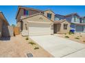 Charming two-story home features a spacious driveway, low maintenance front yard, and inviting entrance at 18456 W Monte Lindo Ln, Surprise, AZ 85387
