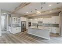 Modern kitchen with white cabinets, stainless steel appliances, and a large island at 18624 W Cathedral Rock Dr, Goodyear, AZ 85338