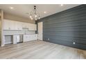 Stylish room with custom cabinets, stainless steel dishwasher, and a modern light fixture at 18624 W Cathedral Rock Dr, Goodyear, AZ 85338
