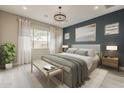 Comfortable main bedroom with stylish decor, soothing colors, and a large window at 18624 W Cathedral Rock Dr, Goodyear, AZ 85338