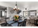 Inviting dining area featuring a chandelier and seamlessly connects to the living room at 1950 E Dust Devil Dr, San Tan Valley, AZ 85143