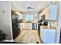 Well-lit kitchen with white cabinetry, stainless appliances, and elegant countertops at 1950 E Dust Devil Dr, San Tan Valley, AZ 85143