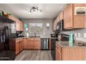 Efficient kitchen featuring stainless steel appliances, wood cabinets, and ample counter space at 1950 E Dust Devil Dr, San Tan Valley, AZ 85143