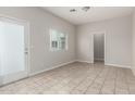 Bright, open room with neutral tile flooring, a large window, and access to other areas at 2000 N 36Th St # 29, Phoenix, AZ 85008
