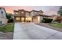 Attractive two-story home boasting stone accents, a spacious driveway, and well-maintained front yard at 21472 E Saddle Ct, Queen Creek, AZ 85142