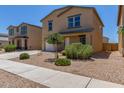 A two story home with a neutral paint scheme and gravel yard for low maintenance landscaping at 255 W Dewey Ave, Coolidge, AZ 85128
