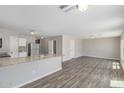 Open floor plan with laminate floors, connecting the living space to the kitchen area at 255 W Dewey Ave, Coolidge, AZ 85128