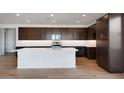 Spacious kitchen with dark cabinets, stainless steel appliances, and a central island at 25616 N 148Th Dr, Surprise, AZ 85387