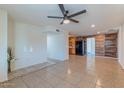 Spacious living room featuring tile floors and wood accent wall, perfect for entertaining at 2625 N 40Th Dr, Phoenix, AZ 85009
