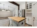 Bright kitchen featuring a stainless steel refrigerator and wood-top kitchen island at 2851 W Gold Dust Ave, San Tan Valley, AZ 85144