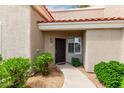 Home exterior showcasing desert landscaping leading to a dark wood front door at 2929 W Yorkshire Dr # 1066, Phoenix, AZ 85027