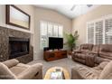 Comfortable living room features a fireplace, carpeted floors, and tan upholstered reclining furniture at 2929 W Yorkshire Dr # 1066, Phoenix, AZ 85027