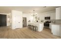Bright kitchen features white cabinetry, stainless steel appliances, and a stylish island with bar seating at 3047 S Chatsworth --, Mesa, AZ 85212