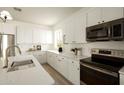 Elegant kitchen featuring white cabinetry, sleek countertops, and stainless steel appliances at 3047 S Chatsworth --, Mesa, AZ 85212