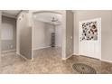 Inviting foyer with neutral walls, decorative floor tile, and an arched entryway into a spacious living area at 3387 E Bluejay Dr, Chandler, AZ 85286