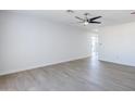 Bright living room features light wood floors and a modern ceiling fan at 340 W Riviera Dr, Tempe, AZ 85282