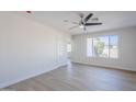 Bright, airy living room featuring modern light fixture, door, and large window at 340 W Riviera Dr, Tempe, AZ 85282