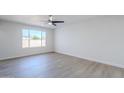 Open living room featuring modern light fixture and a bright window at 340 W Riviera Dr, Tempe, AZ 85282