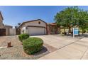 Charming single-story home with stucco and stone accents, tile roof, and a well-manicured front yard at 36197 W Cartegna Ln, Maricopa, AZ 85138