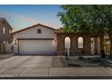 Charming single-story home with stucco and stone accents, tile roof, and a well-manicured front yard at 36197 W Cartegna Ln, Maricopa, AZ 85138