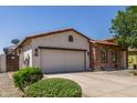 Charming single-story home with stucco and stone accents, tile roof, and a well-manicured front yard at 36197 W Cartegna Ln, Maricopa, AZ 85138