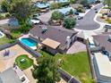 Backyard featuring lush lawn area, pool, patio with shade cover, and play area at 4115 W Danbury Dr, Glendale, AZ 85308