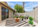 Relaxing outdoor space with a covered patio, artificial turf, and stylish seating area at 5052 W Boston S Way, Chandler, AZ 85226