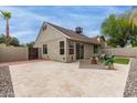 Spacious backyard with a large patio area, artificial turf, and privacy fencing at 5052 W Boston S Way, Chandler, AZ 85226