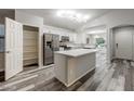 Open-concept kitchen features a central island, stainless steel appliances, and ample storage at 6920 S 46Th Dr, Laveen, AZ 85339