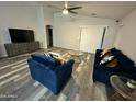 Cozy living room featuring vaulted ceiling, modern furniture, and sliding glass door access at 6920 S 46Th Dr, Laveen, AZ 85339